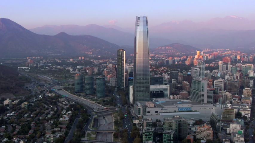 Aerial view of Santiago, the capital and largest city in Chile, showing landmark buildings in the financial district at sunset. Royalty-Free Stock Footage #1049695912