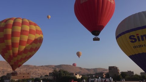 LUXOR, EGYPT - CIRCA NOV 2019: Starting flying hot-air balloons at sunrise, 4k