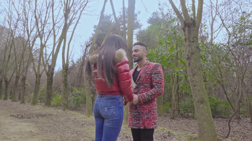 Happy Young Loving Couple Looking At Each Other In Park,the camera rotates around a couple