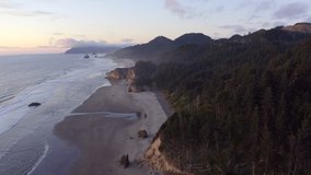 Sunset Aerial Tour of Cannon Beach and Arch Cape, Oregon. Haystack Rock can be seen in the distance and also the popular Hug Point State Recreation Site. 