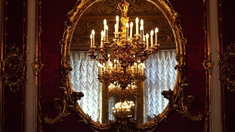 SAINT PETERSBURG, RUSSIA - JUNE 18, 2019: Golden chandeliers in mirror. Interior of Hermitage museum, Winter Palace, Saint Petersburg. Historic art & culture tourism, family travel destination Russia