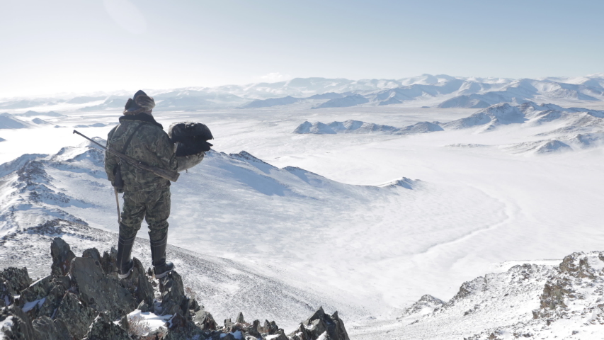 Hunter releases his eagle to fly off into the mountains.