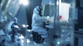 Coronavirus, covid-19, virus research concept. Laboratory worker in protective suit works with covid-19 samples. - Powered by Shutterstock - Get 15% off with code: PIKWIZARD15