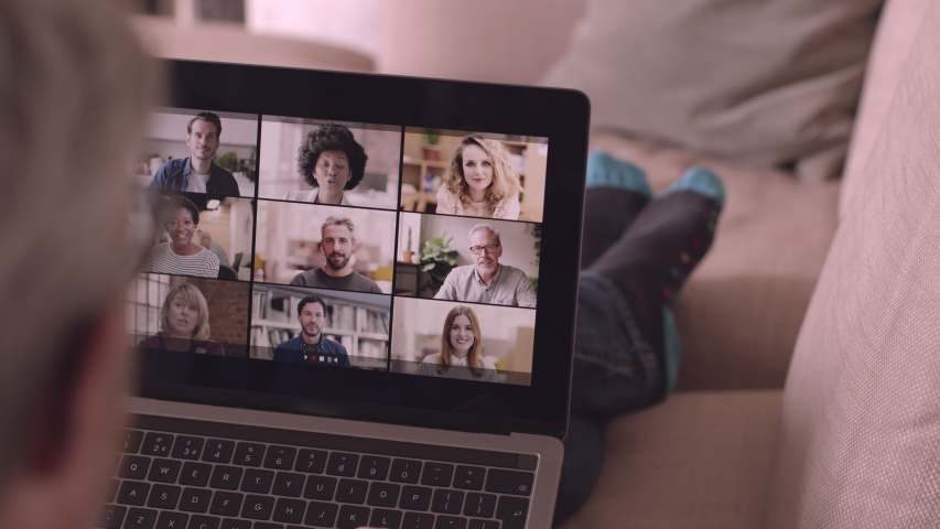 Person Using Video Conferencing technology from sofa for video call with colleagues at home and in offices