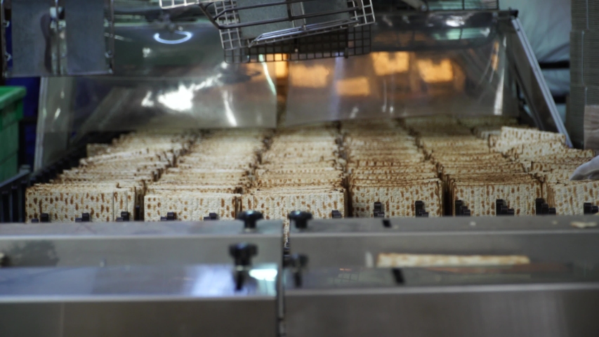 workers sorting fresh baked matzo 