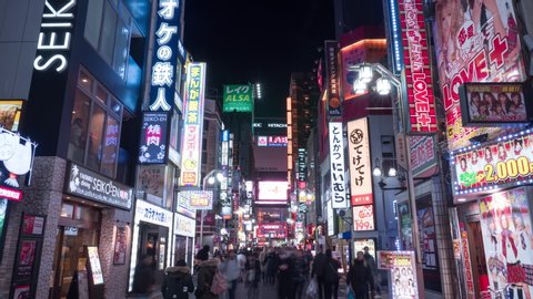 TOKYO, JAPAN - 2020 circa: Crowd of people in Kabukicho district of Shinjuku ward, Asian nightlife concept. 4K hyperlapse
