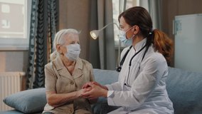 Female nurse talking with elderly woman patient, holds hands. Doctor home visit, checking health of old senior woman during coronavirus, covid-19 quarantine, self isolation. - Powered by Shutterstock - Get 15% off with code: PIKWIZARD15