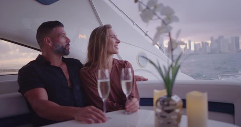 Couple drinking champagne on yacht