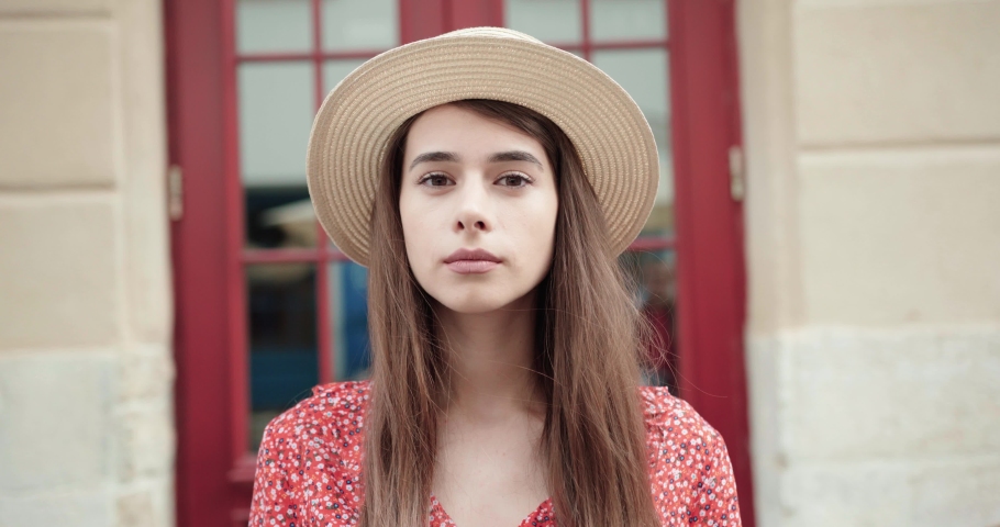 Portrait of a beautiful young lady in a straw hat. Girl in hat.