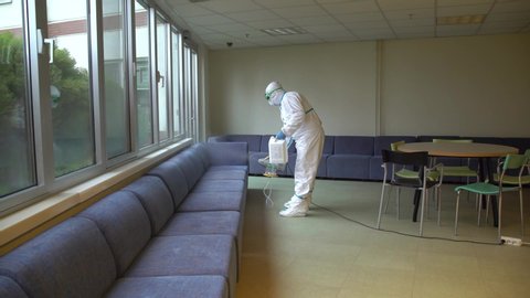 Masked Disinfectant Workers Spraying Sanitizer to Library and Class and Living Areas in Schools for Coronavirus Disease Covid-19 4K High Quality Video Men Working Against Corona Cleaning Public Spaces