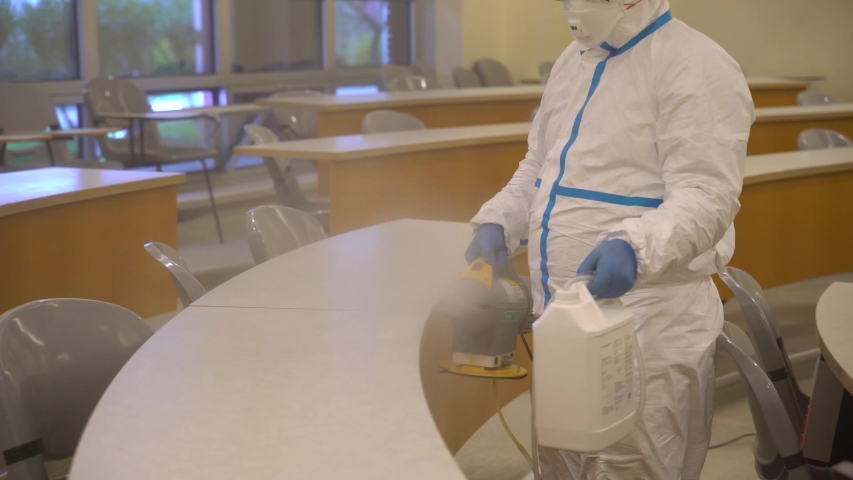 Masked Disinfectant Workers Spraying Sanitizer to Library and Class and Living Areas in Schools for Coronavirus Disease Covid-19 4K High Quality Video Men Working Against Corona Cleaning Public Spaces Royalty-Free Stock Footage #1049776132