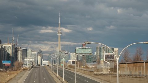 Toronto, Ontario, Canada - Mar 29, 20: Aerial video of empty Gardiner expressway with no traffic due to covid-19 corona virus outbreak pandemic quarantine. View of downtown and CN Tower.
