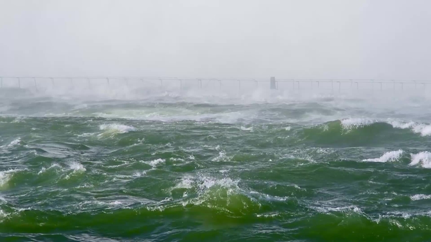 Hurricane and severe flood, waves hitting bridge near coast