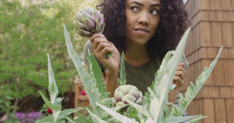 Cute woman dancing with vegetables