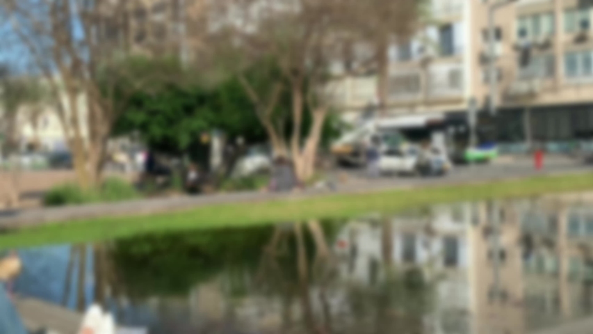 Artificial pond with building reflection on water at Rabin Square in Tel Aviv. Ibn Gvirol Street. 4K. Blurred view