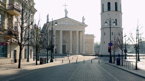 VILNIUS, LITHUANIA - MARCH 28 2020. Drone footage with pull back from Cathedral square over empty Gediminas Avenue in the center of Vilnius. 