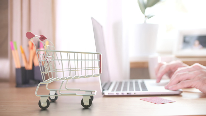 Delivered boxes fall in shopping cart right after placing online store order by customer Royalty-Free Stock Footage #1049816071