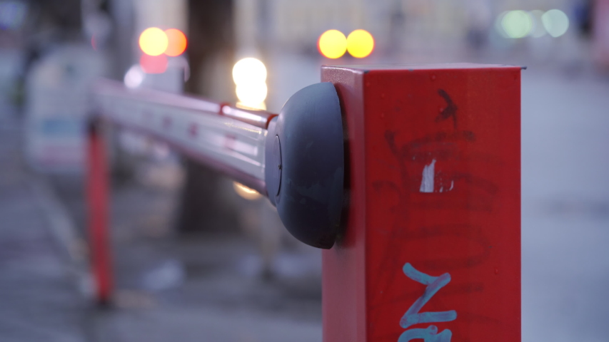 Parking lot automatic road boom barrier system gate on a city street.
