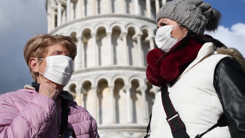 Woman wearing health mask visiting Field of Miracles, slow motion, Pisa.