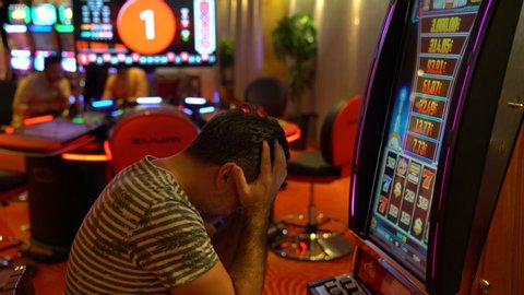 Casino on a slot machine, happy man winning. The playing slot machines in the casino. 27.January.2020 Costa Cruiser Ship