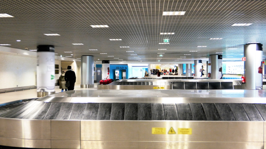 A baggage reclaim area of a large European airport lies almost empty after the COVID-19 pandemic caused massive travel disruptions Royalty-Free Stock Footage #1049845045