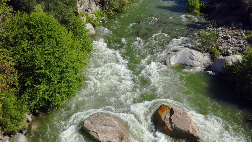 Flying over the Kaweah River whitewater flowing from the snow melt high in the Sequoia National Park through the foothill town of Three Rivers, California.