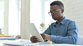 Excited Young African Man doing Video Chat on Tablet in Office 