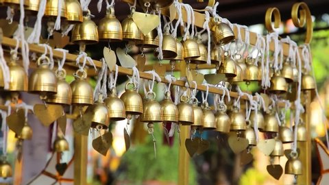 Blowing wind in the afternoon,Thai golden buddhist bells are being rung and yearning for luck and peace. 