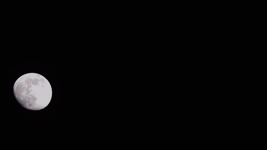 Nearly Fullmoon is rising over the night Sky. | Shutterstock HD Video #1049871361