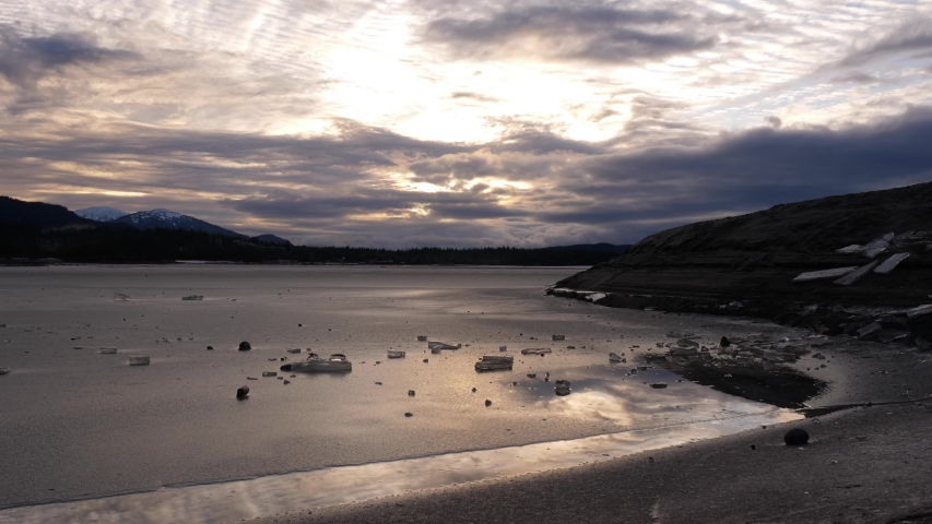 Time lapse of clouds moving over a partially frozen Mendenhall lake in the fall. 4K 30fps