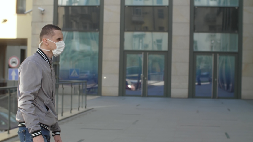 Friends in protective masks meet on the street. Royalty-Free Stock Footage #1049888374