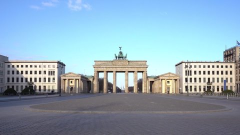 berlin, germany, 05.04.2020: view on the famous Brandenburg gate on the Pariser square in Berlin city, parisian square without tourists and visitors - deserted, blue sky, small clouds