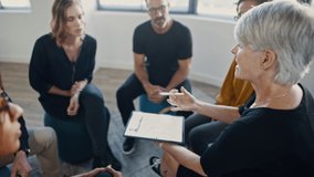 Senior coach conducting a personal development training program with employees. Mentor using a digital tablet and giving training to corporate office workers.
 - Powered by Shutterstock - Get 15% off with code: PIKWIZARD15