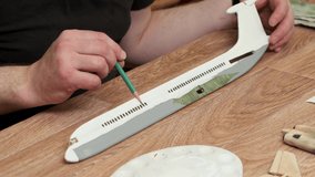 teacher points to wooden part of passenger jetliner model with pencil at table explaining at masterclass close view slow motion - Powered by Shutterstock - Get 15% off with code: PIKWIZARD15