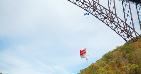 Fayetteville, Tennessee / USA - November 14 2019: Base Jumper With Parachute, Slow Motion Through Sky, Forest