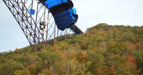 Fayetteville, Tennessee / USA - November 14 2019: Base Jumper With Parachute, Slow Motion, Forest Landscape