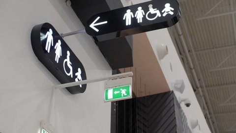 Motion of man and woman washroom logo on wall