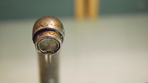 dripping old, rusty kitchen faucet. water dripping from a tap close up. Lack of clean water, reckless use of resources
