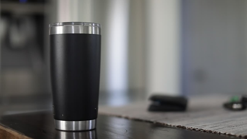 Man taking car key, wallet and tumbler with coffee out of table. Close up of hand taking tumbler with coffee to go in the kitchen Royalty-Free Stock Footage #1049918308