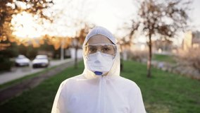 Disinfection service worker in hazmat suit with N95 mask and protective glasses.Private protective equipment (PPE).Quarantined area decontamination.Female physician in uniform on fronline.Video in 4K