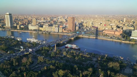 CAIRO, EGYPT - CIRCA 2020: Aerial view of Cairo. River Nile and city skyilne at sunset. Panning left.