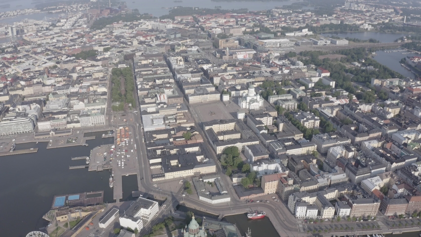 Helsinki, Finland. A sweeping aerial view captures the neoclassical heart of the Finnish capital, with the gleaming white Helsinki Cathedral standing prominently at the northern end of Senate Square. The cathedral