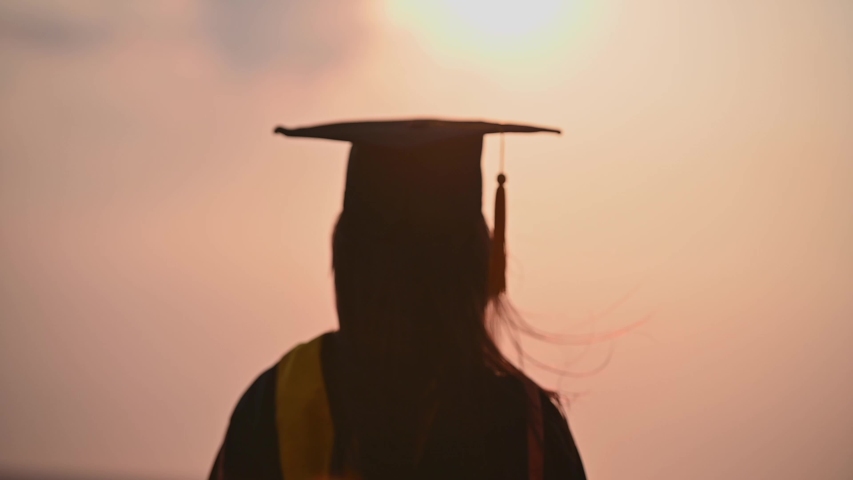 Abstract Close up Rear view of the university graduates at Silhouette sunset | Shutterstock HD Video #1049930344