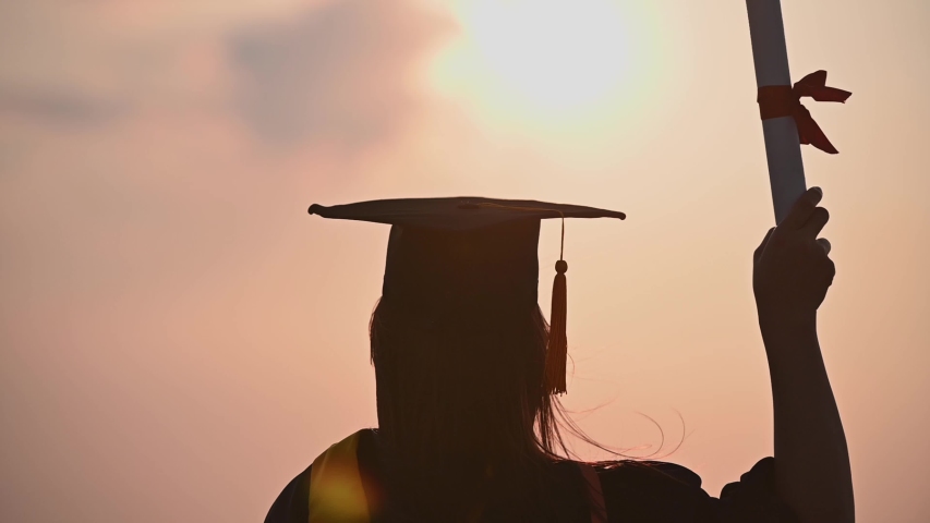 Abstract Close up Rear view of the university graduates at Silhouette sunset | Shutterstock HD Video #1049930344