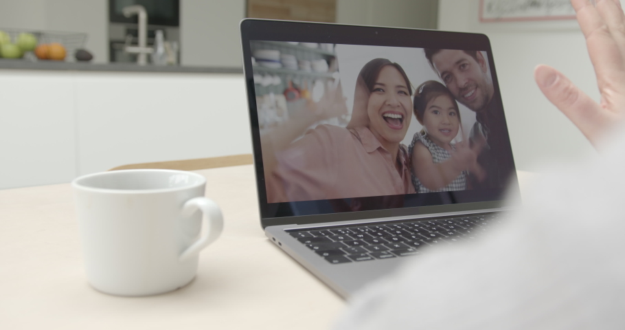 Family Using video call at home to connect with relatives at home in kitchen during covid-19 lockdown Royalty-Free Stock Footage #1049941525