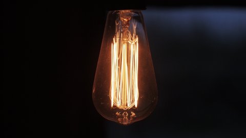 4k Close-up Of A Tungsten Light Bulb Switching On And Off. Energy, Electricity, Innovation Concept. 