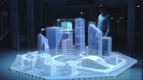 Industry 4.0: Modern Professional Architect Wearing Virtual Reality Headset Uses Gestures to Move, Design and Manipulate Buildings for 3D City. Mixed Augmented Reality Software. VFX Visual Effects