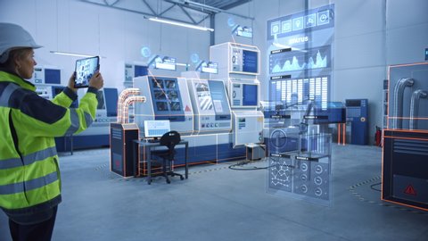 Industry 4.0 Factory: Female Engineer Uses Digital Tablet Computer with Augmented Reality Software to Connect with CNC Machinery, Robot Arm and Visualize Maintenance and Diagnostics of the Equipment