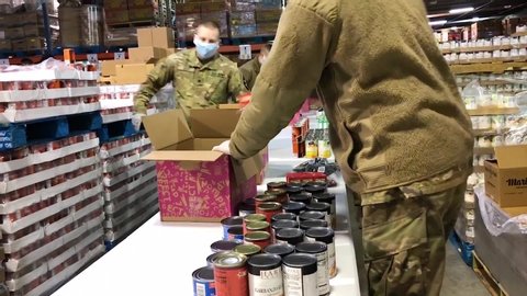 CIRCA 2020 - U.S. army soldiers distribute food at a Lakewood, Washington food bank during the Covid-19 corona virus outbreak food shortage.