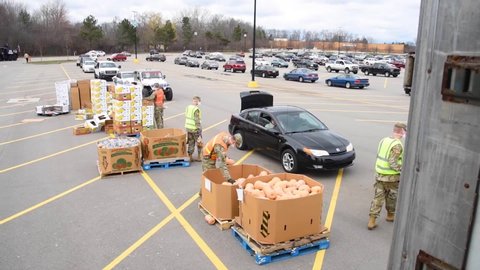 CIRCA 2020 - U.S. army soldiers distribute food at a West Michigan food bank during the Covid-19 outbreak food shortage.